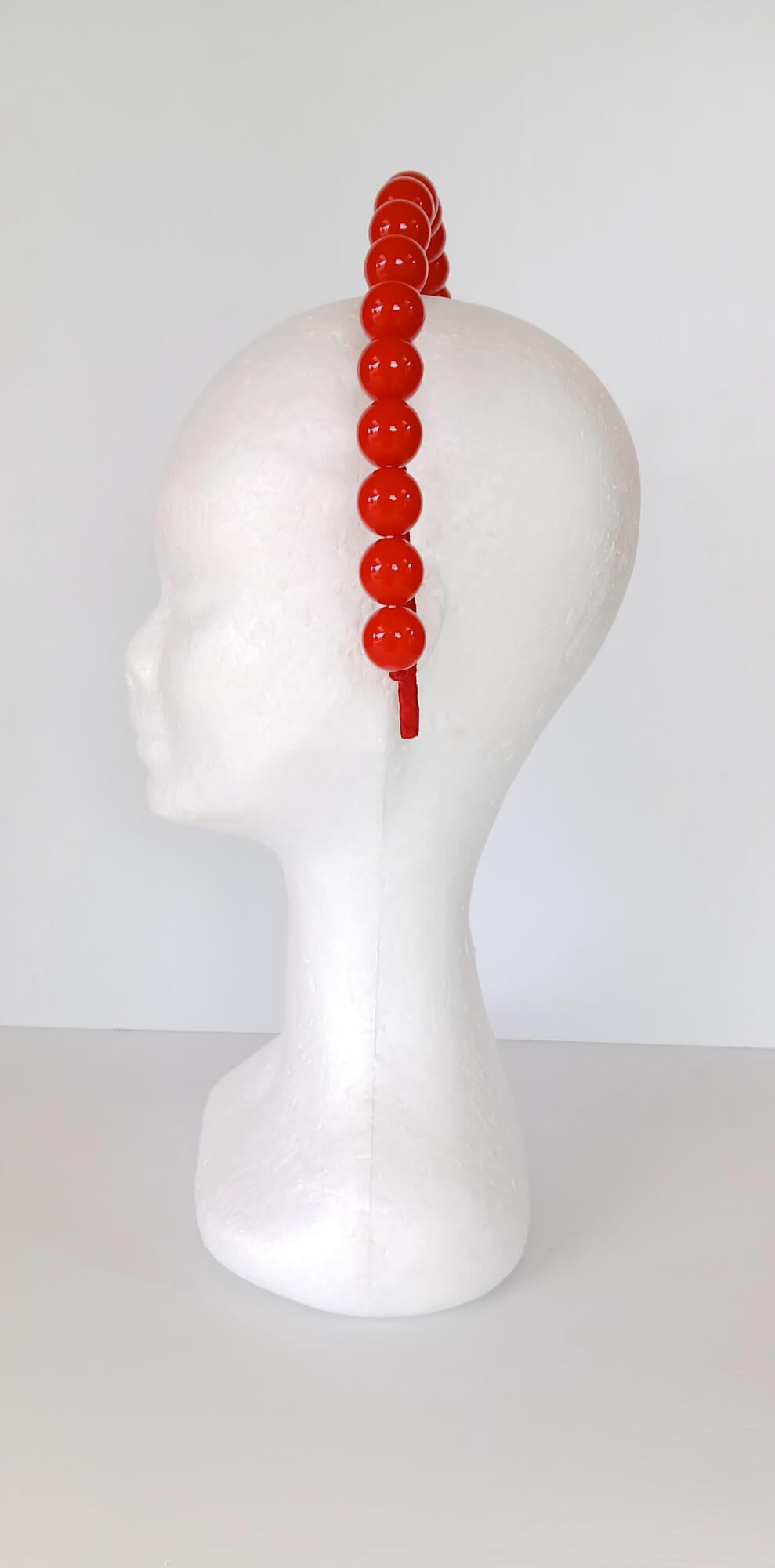 A picture of a Red Beaded Headband by Melissa Rath  Millinery.