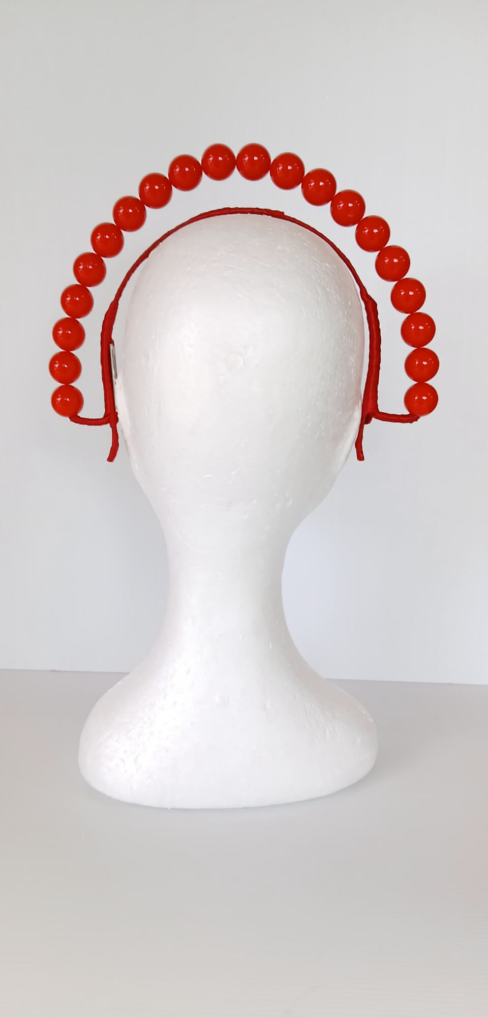 A picture of a Red Beaded Headband by Melissa Rath  Millinery.