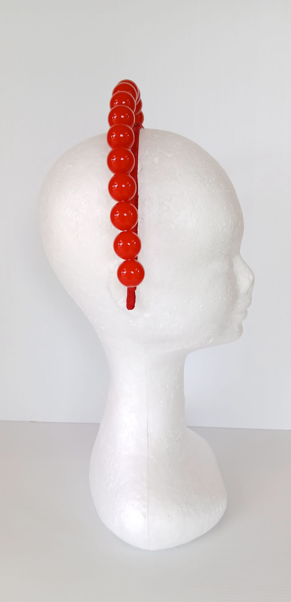 A picture of a Red Beaded Headband by Melissa Rath  Millinery.