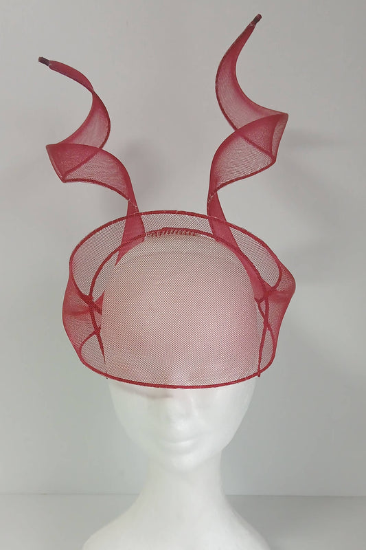 A picture of a red crinoline millinery veil with double swirls by Melissa Rath Millinery