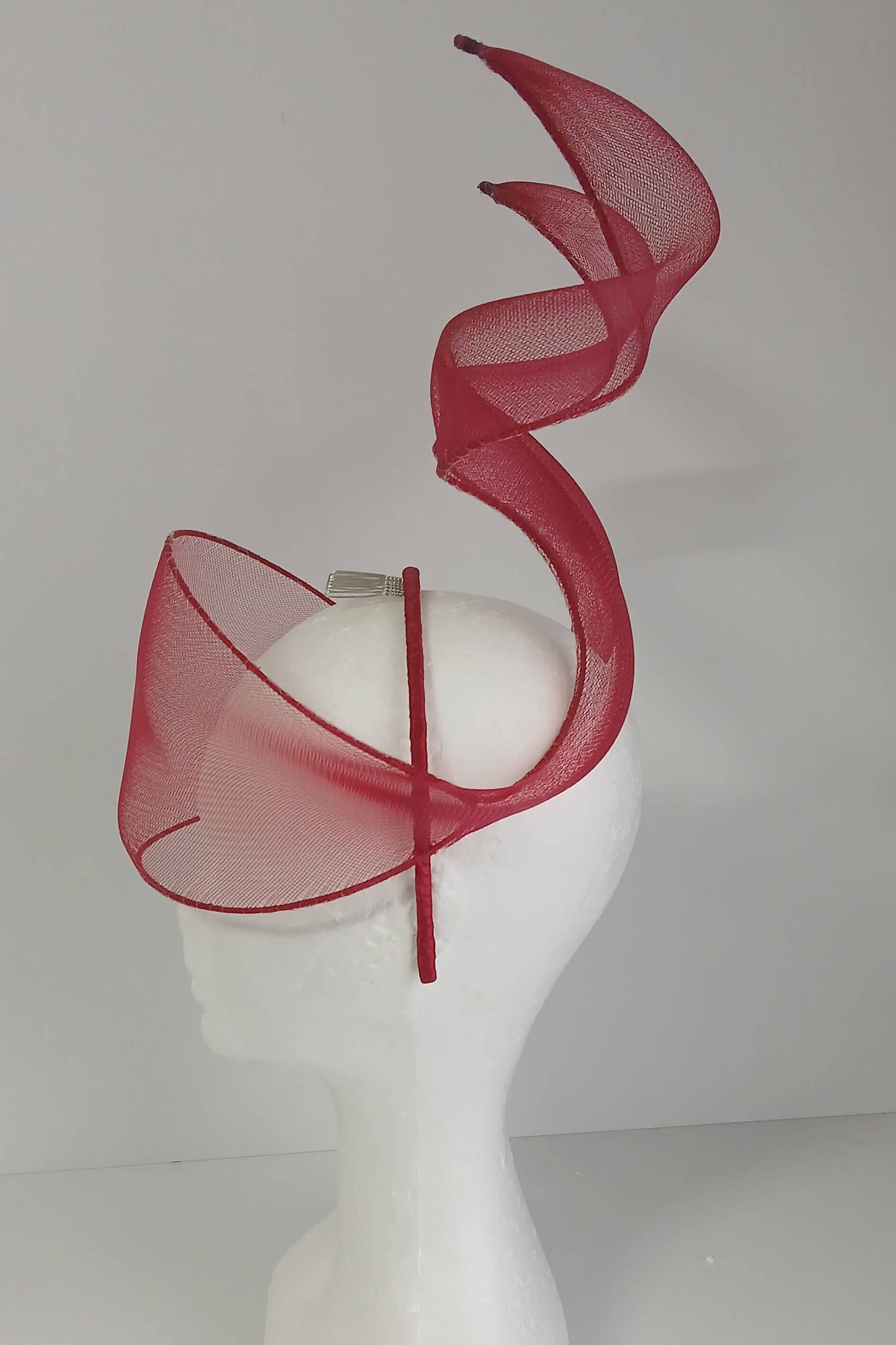 A picture of a red crinoline millinery veil with double swirls by Melissa Rath Millinery
