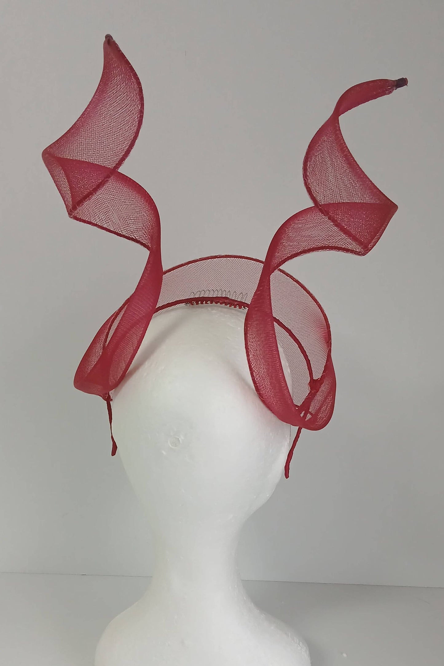 A picture of a red crinoline millinery veil with double swirls by Melissa Rath Millinery