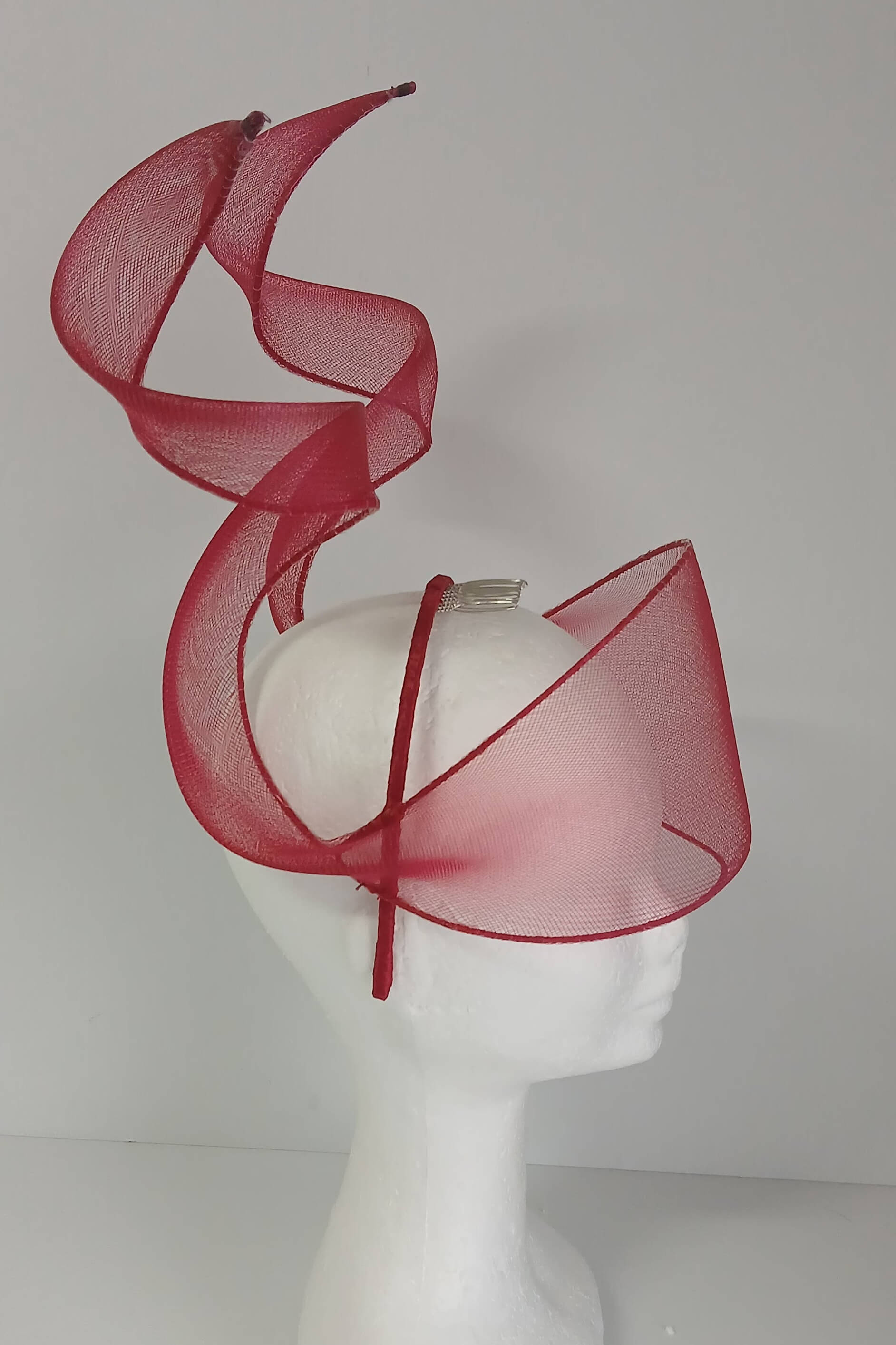 A picture of a red crinoline millinery veil with double swirls by Melissa Rath Millinery