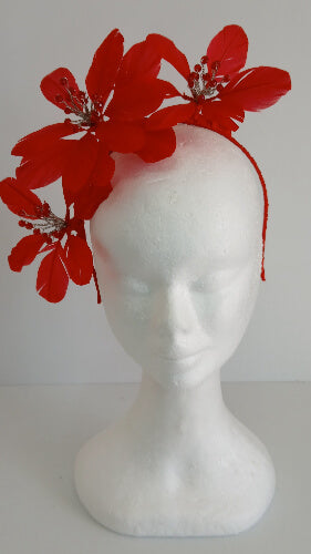 A picture of a red feather flower millinery headband by Melissa Rath iillinery.
