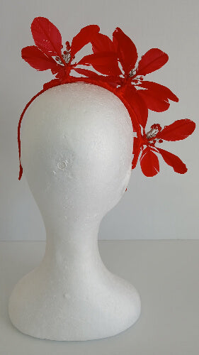 A picture of a red feather flower millinery headband by Melissa Rath iillinery.