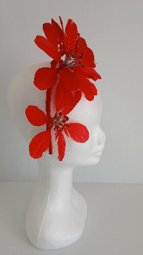 A picture of a red feather flower millinery headband by Melissa Rath iillinery.