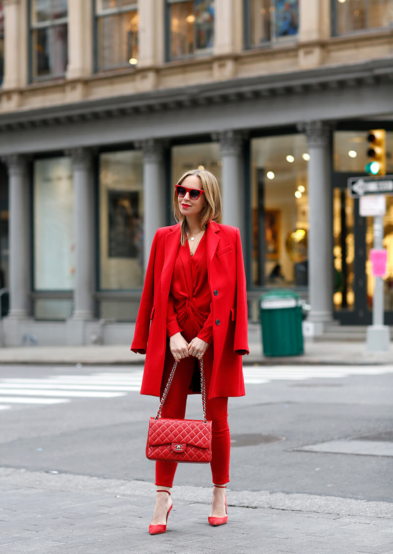 A picture of a woman wearing an outfit in a red monochromatic colour scheme.