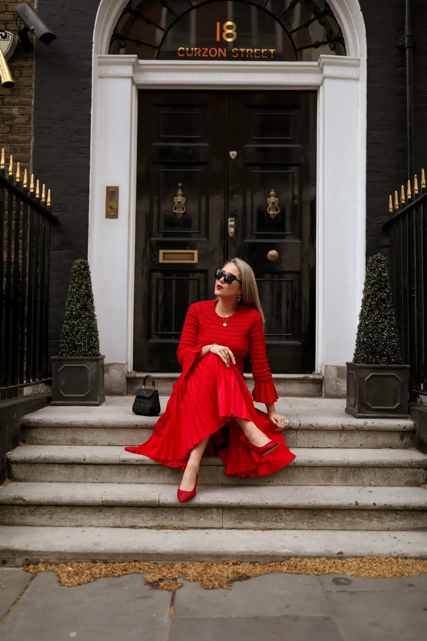 A picture of a woman wearing an outfit in a red monochromatic colour scheme.