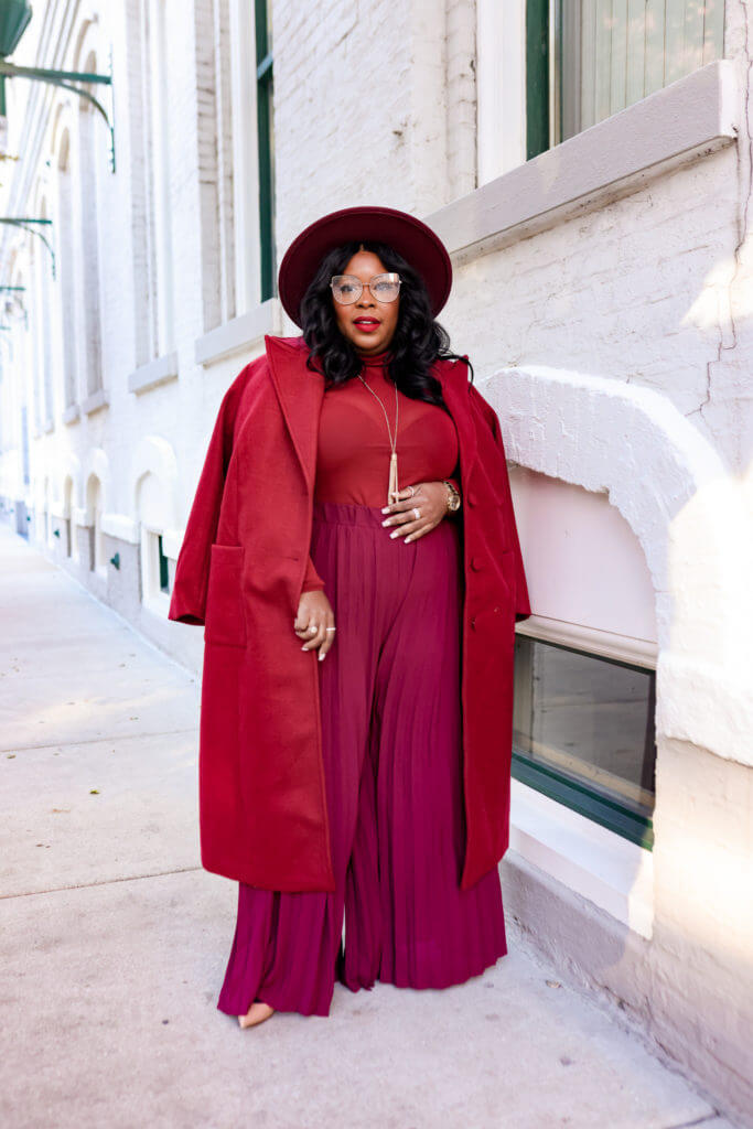 A picture of a woman wearing an outfit in a red monochromatic colour scheme.