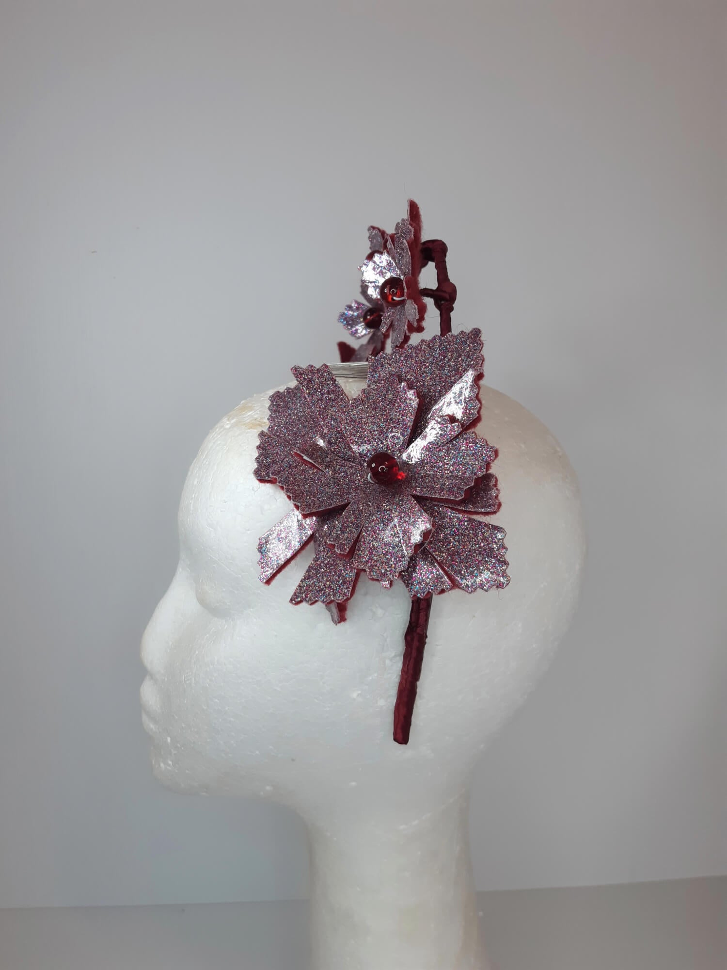 A picture of a red millinery crown halo by Melissa Rath Millinery.