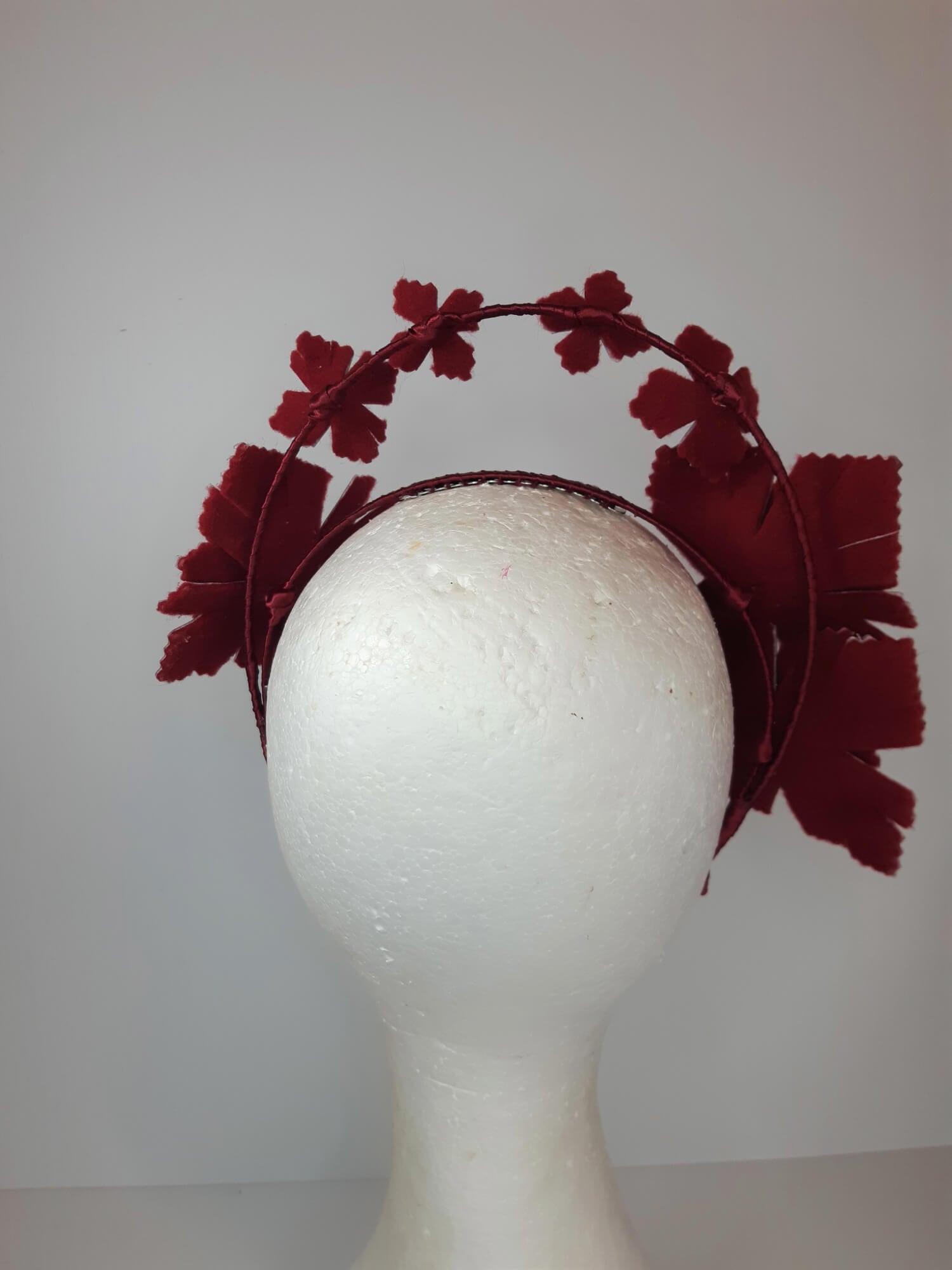 A picture of a red millinery crown halo by Melissa Rath Millinery.