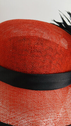 A picture of a red and black millinery cloche by Melissa Rath Millinery.