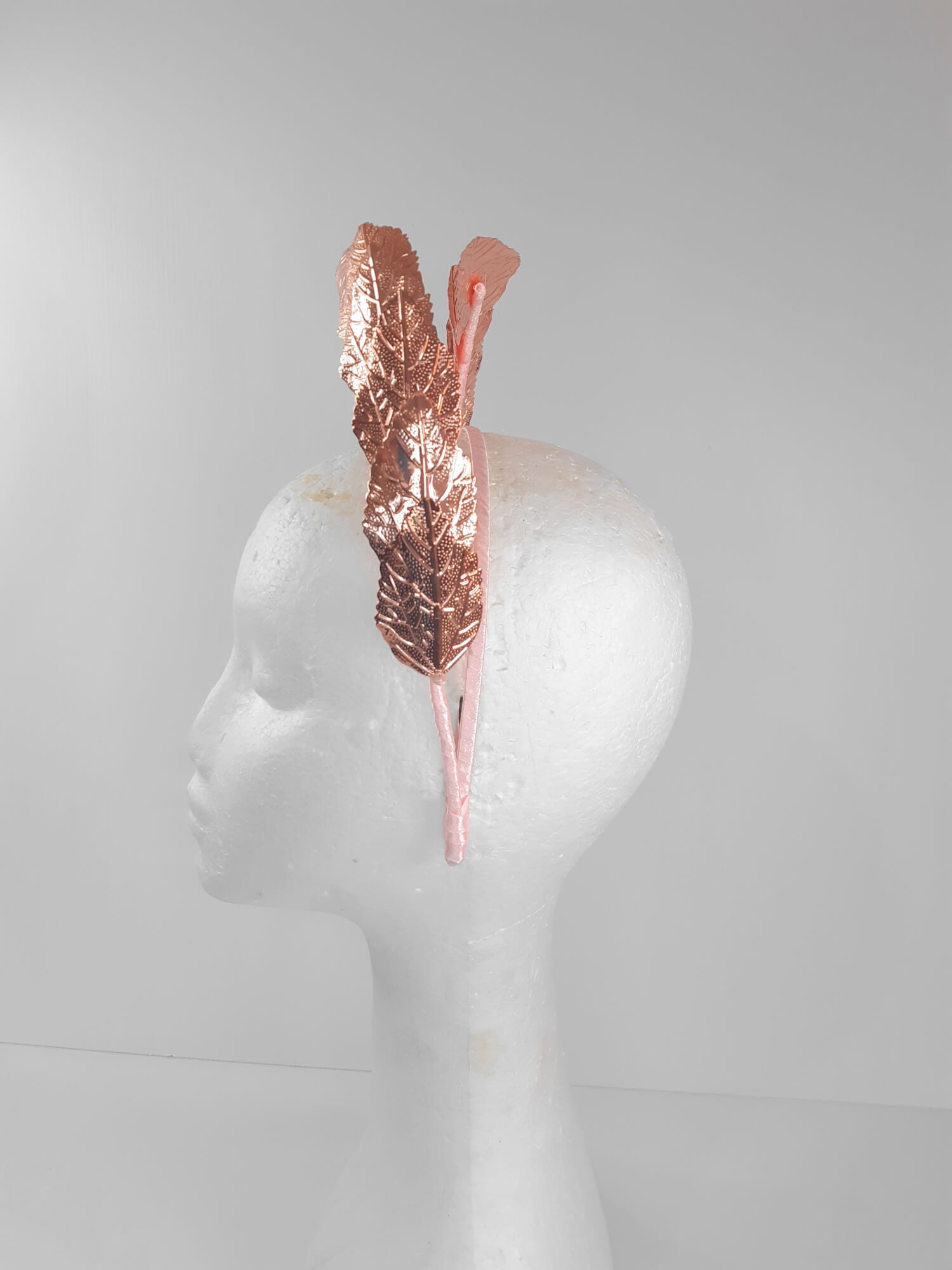 A picture of a Rose Gold Leaf Millinery Headband by Melissa Rath Millinery.