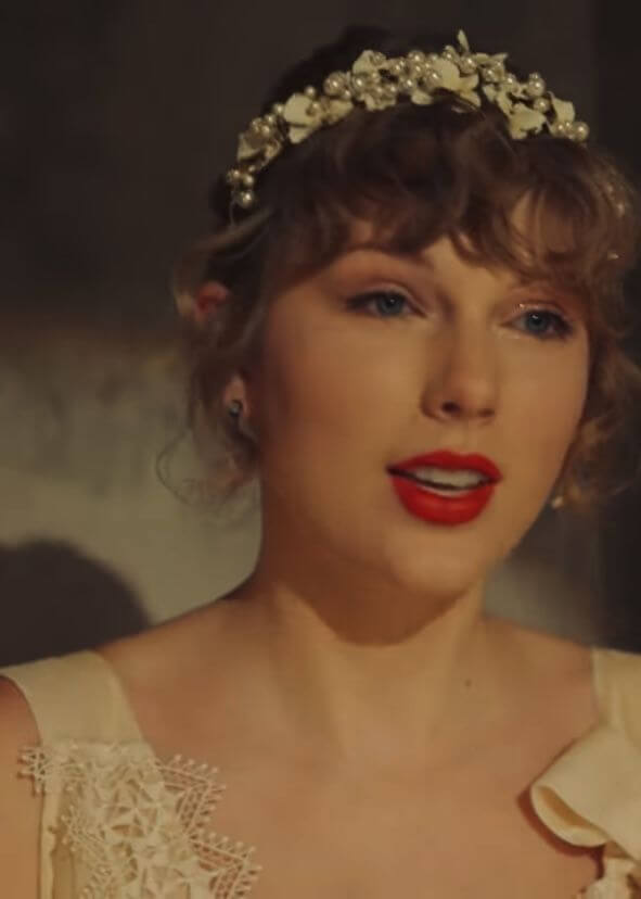 A picture of Taylor Swift wearing a millinery crown.