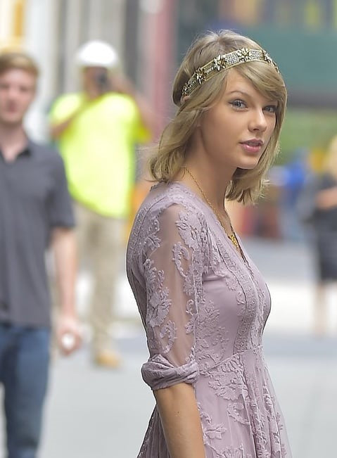 A picture of Taylor Swift wearing a millinery crown.