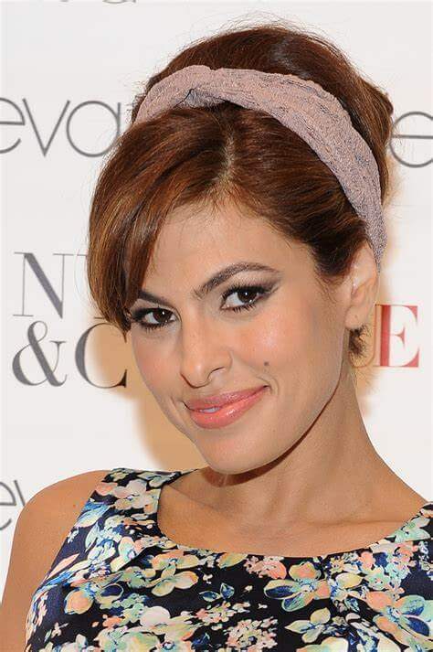 A picture of a hair style suggestion for the Red Pleather Heart Headband by Melissa Rath Millinery.