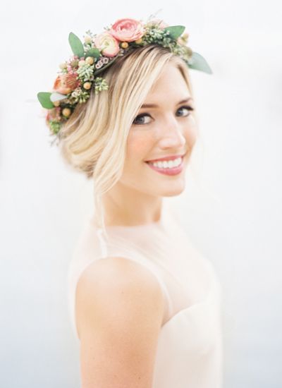 A picture of a lady wearing a millinery crown with an up do.