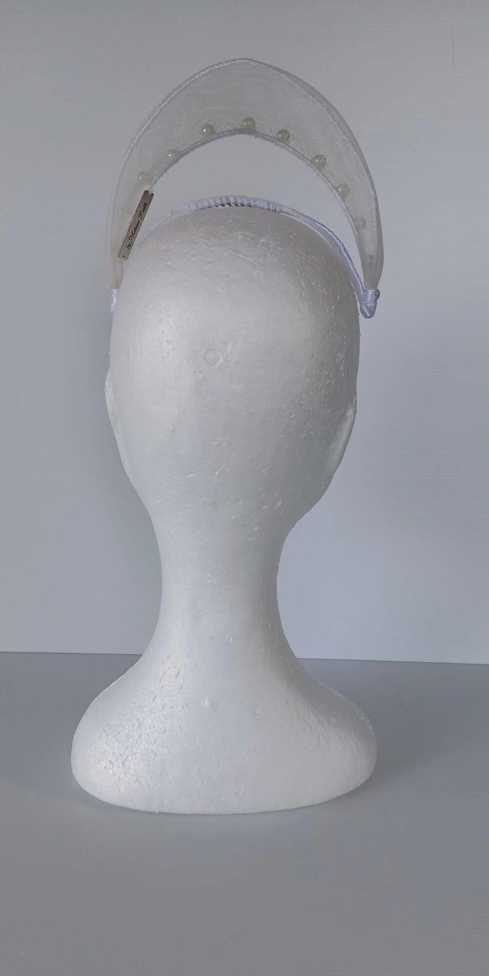 A picture of a White Crinoline Floating Millinery Crown by Melissa Rath Millinery.