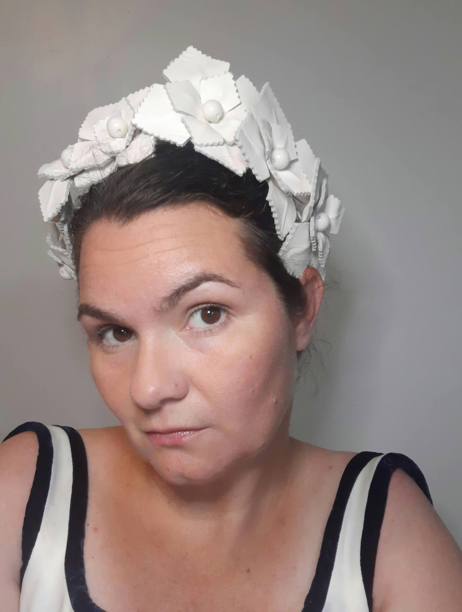 A picture of a white leather millinery crown by Melissa Rath Millinery.