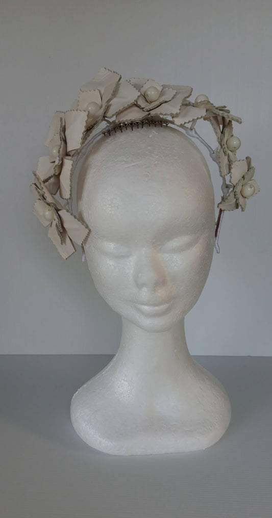 A picture of a white leather millinery crown by Melissa Rath Millinery.