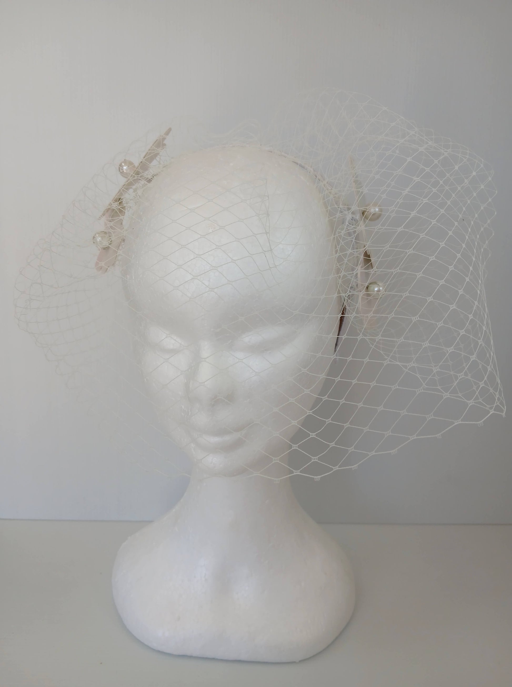 A picture of a White Pleather Headband by Melissa Rath Millinery