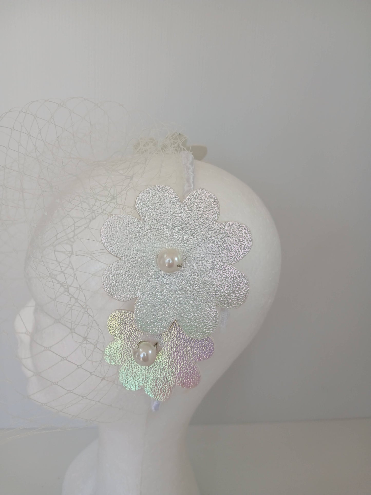 A picture of a White Pleather Headband by Melissa Rath Millinery