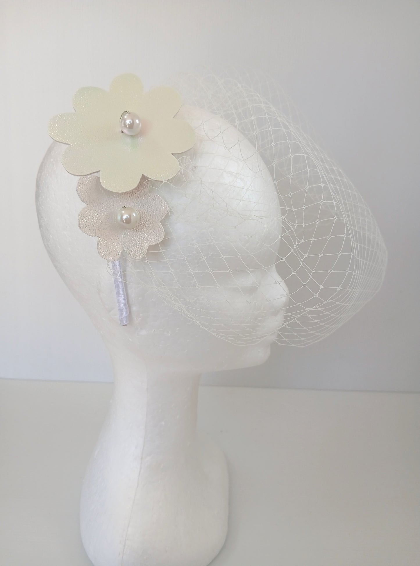 A picture of a White Pleather Headband by Melissa Rath Millinery