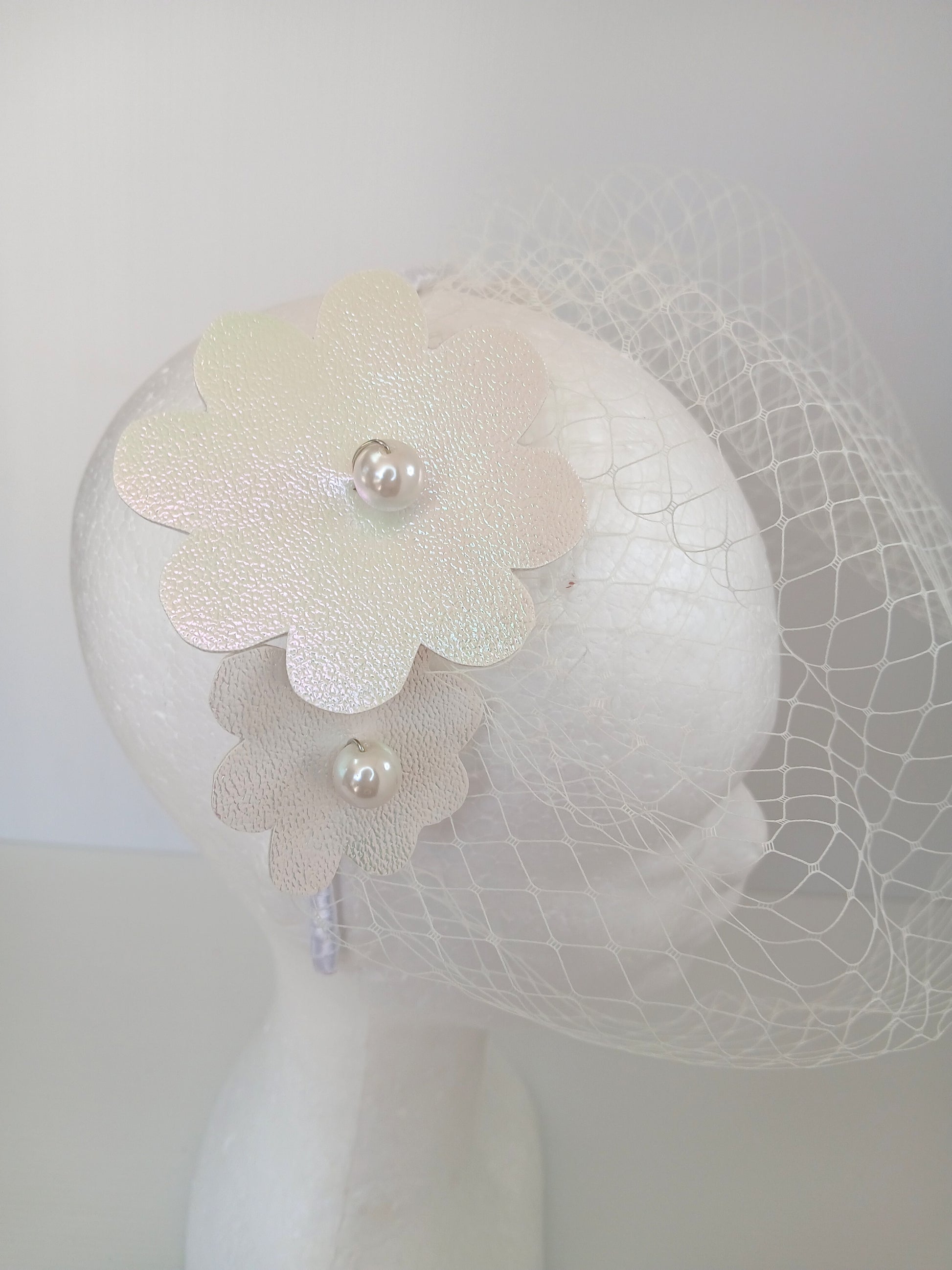 A picture of a White Pleather Headband by Melissa Rath Millinery