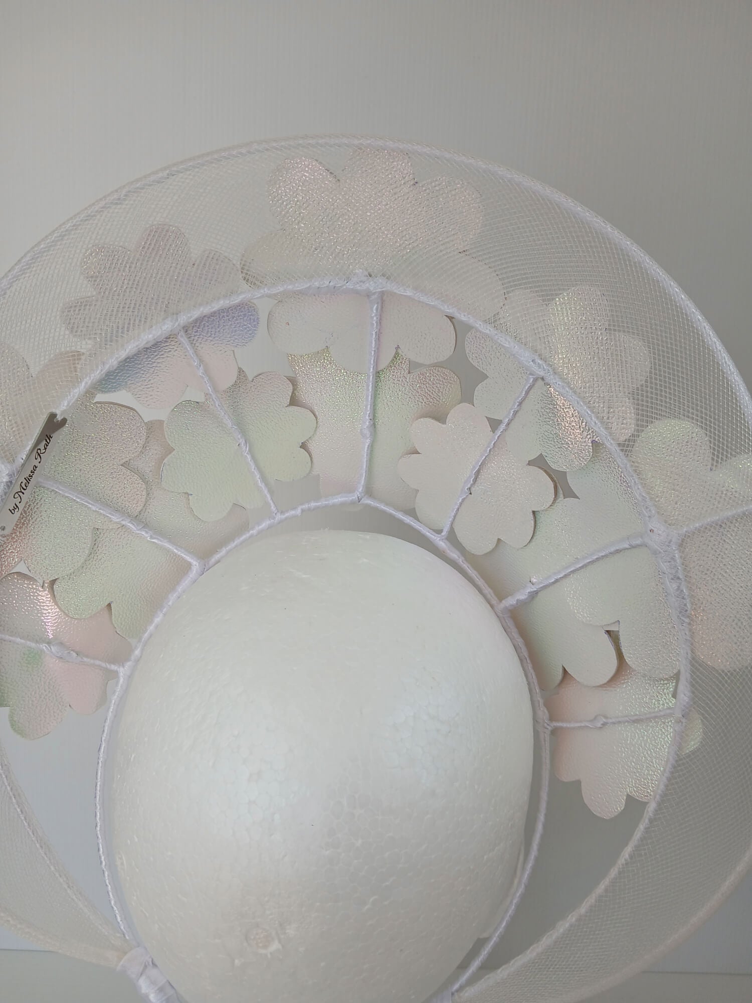 A picture of a White Pleather and Crinoline Millinery Halo Crown by Melissa Rath Millinery.