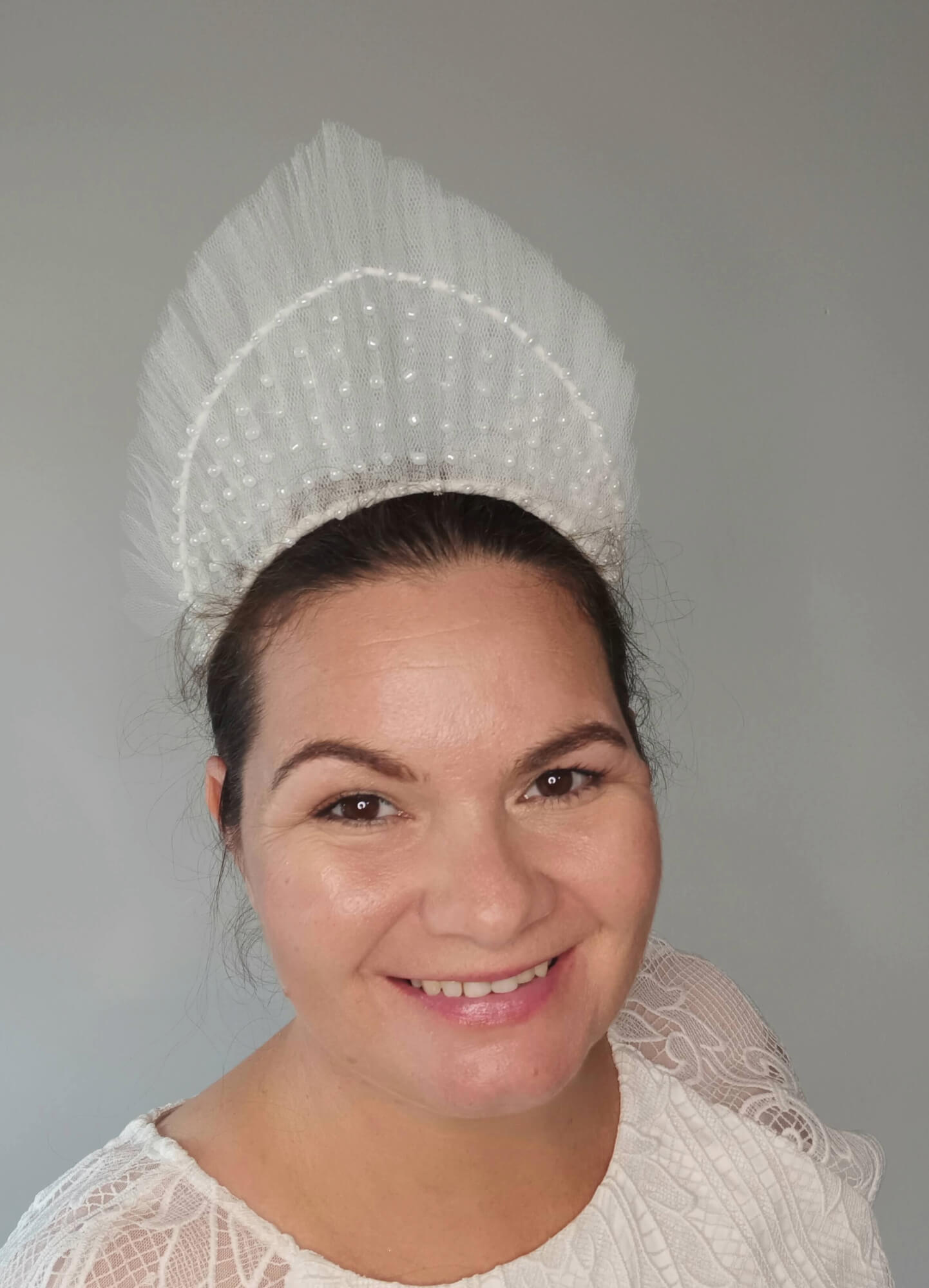 A picture of a White Beaded Tulle Millinery Crown by Melissa Rath Millinery.