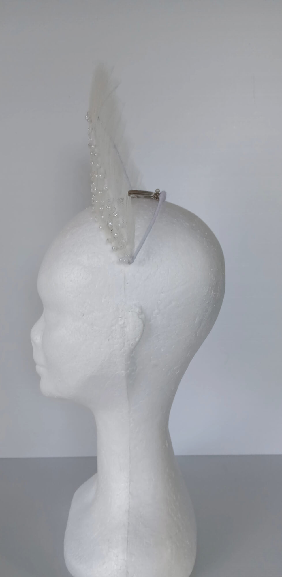 A picture of a White Beaded Tulle Millinery Crown by Melissa Rath Millinery.