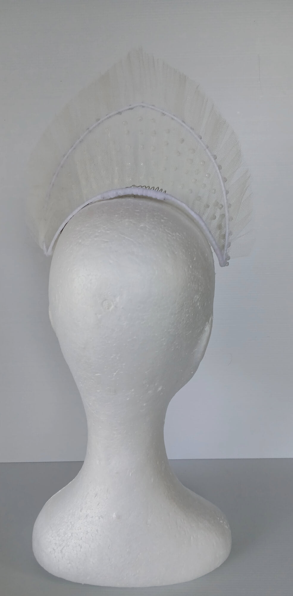 A picture of a White Beaded Tulle Millinery Crown by Melissa Rath Millinery.