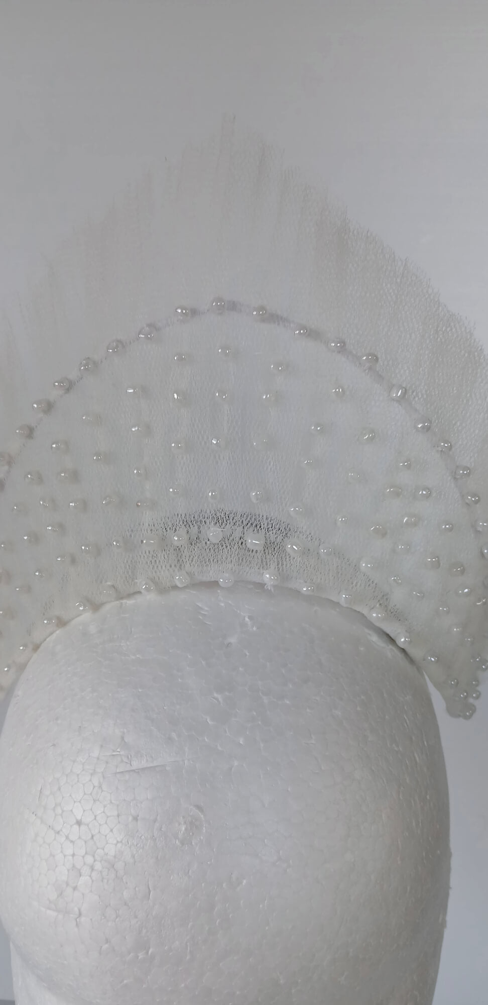 A picture of a White Beaded Tulle Millinery Crown by Melissa Rath Millinery.