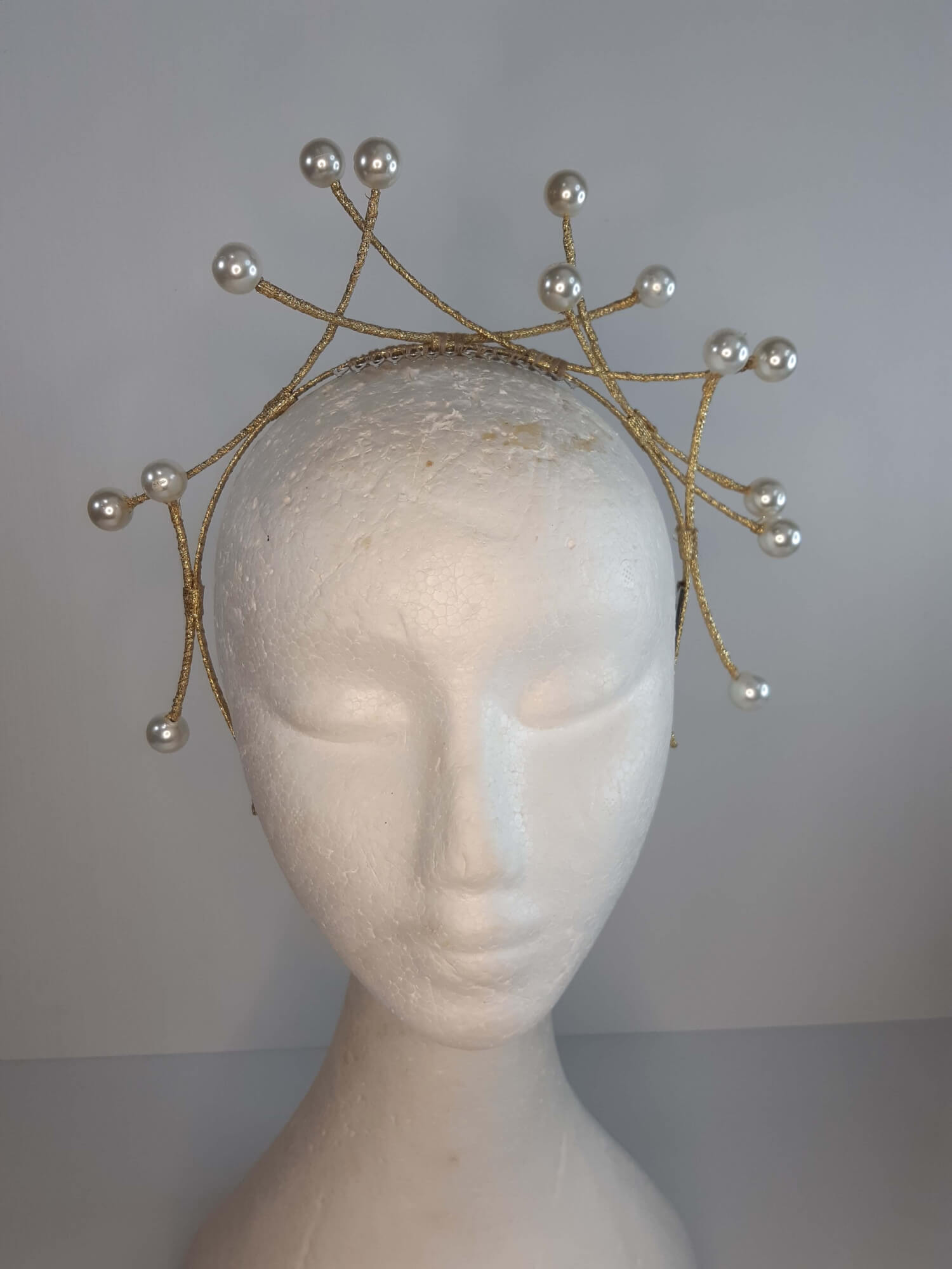 A picture of a cream and gold beaded millinery headband by Melissa Rath Millinery.