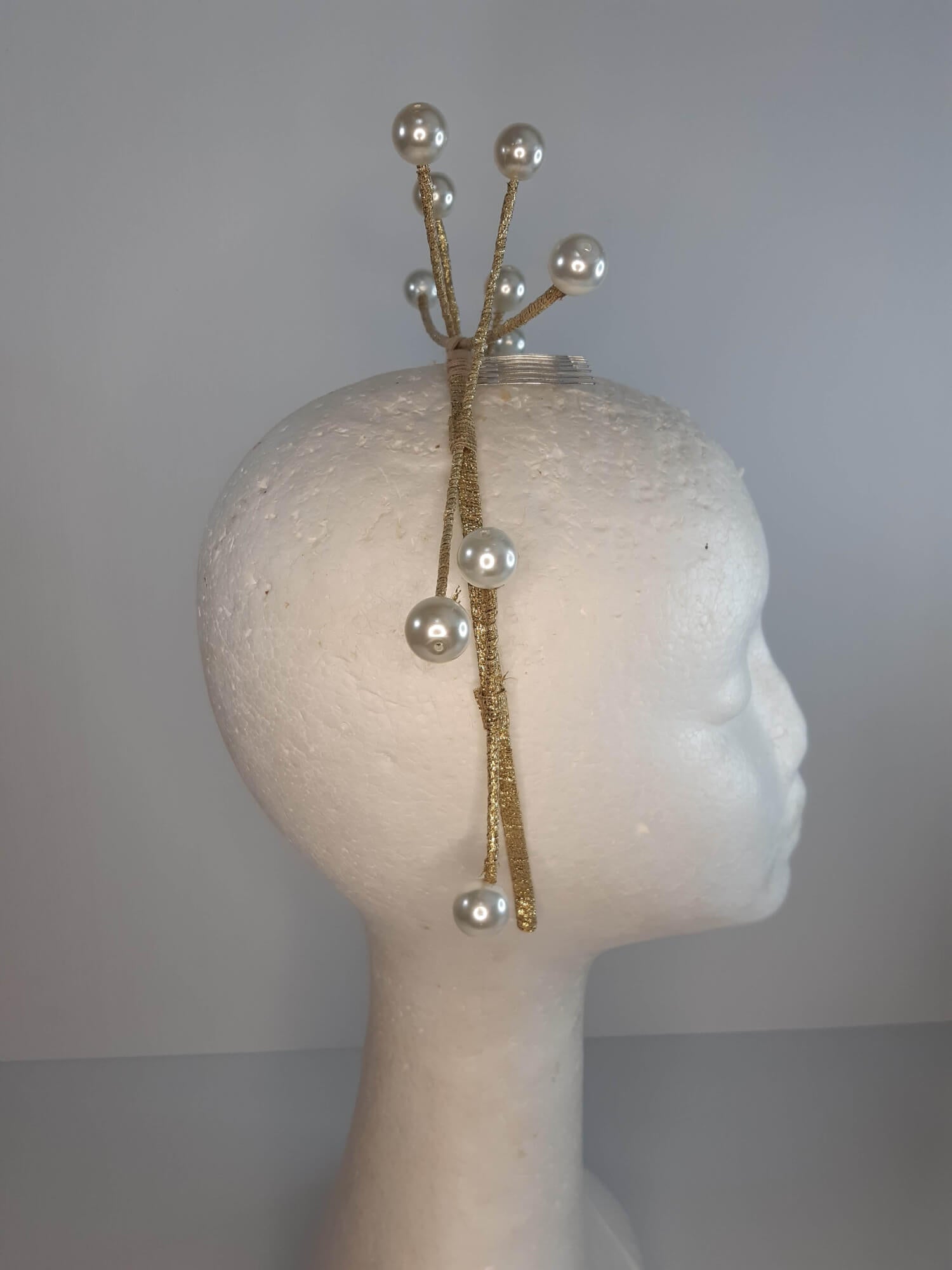 A picture of a cream and gold beaded millinery headband by Melissa Rath Millinery.