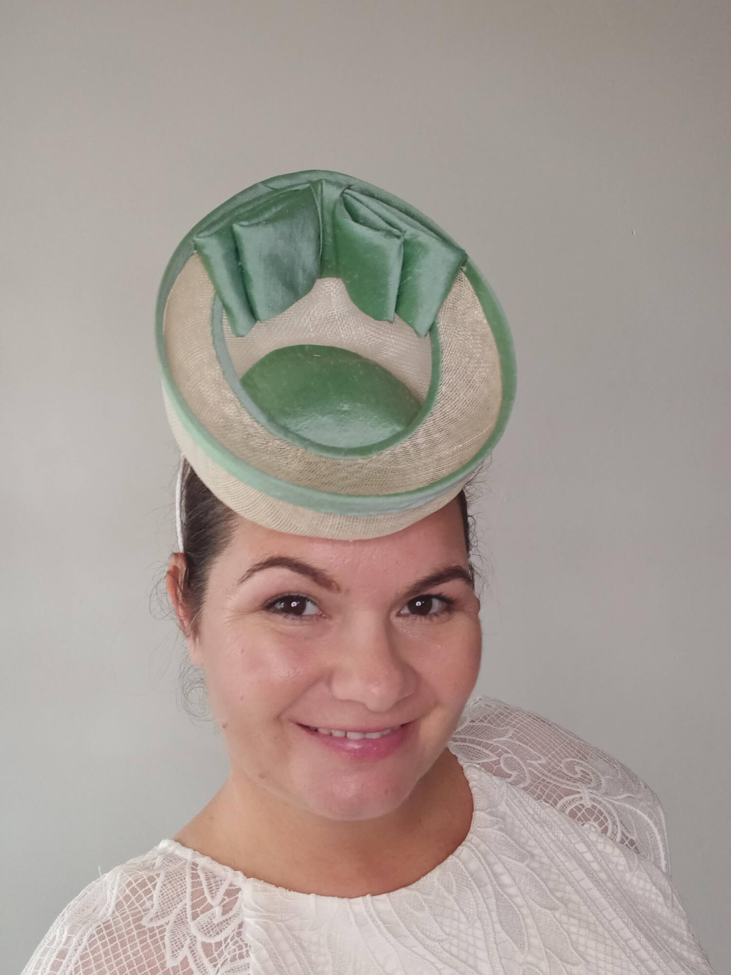 A picture of a White and Green Saucer Hat by Melissa Rath Millinery