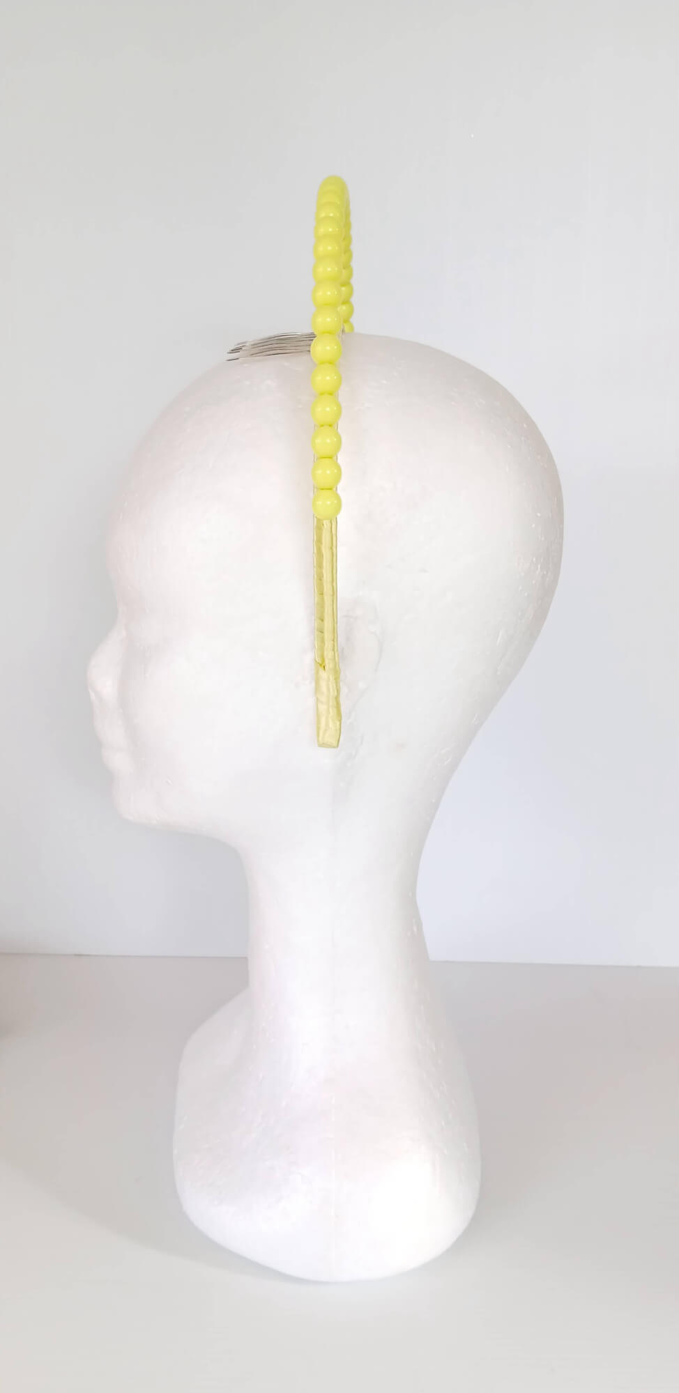 A picture of a Yellow Beaded Headband by Melissa Rath Millinery