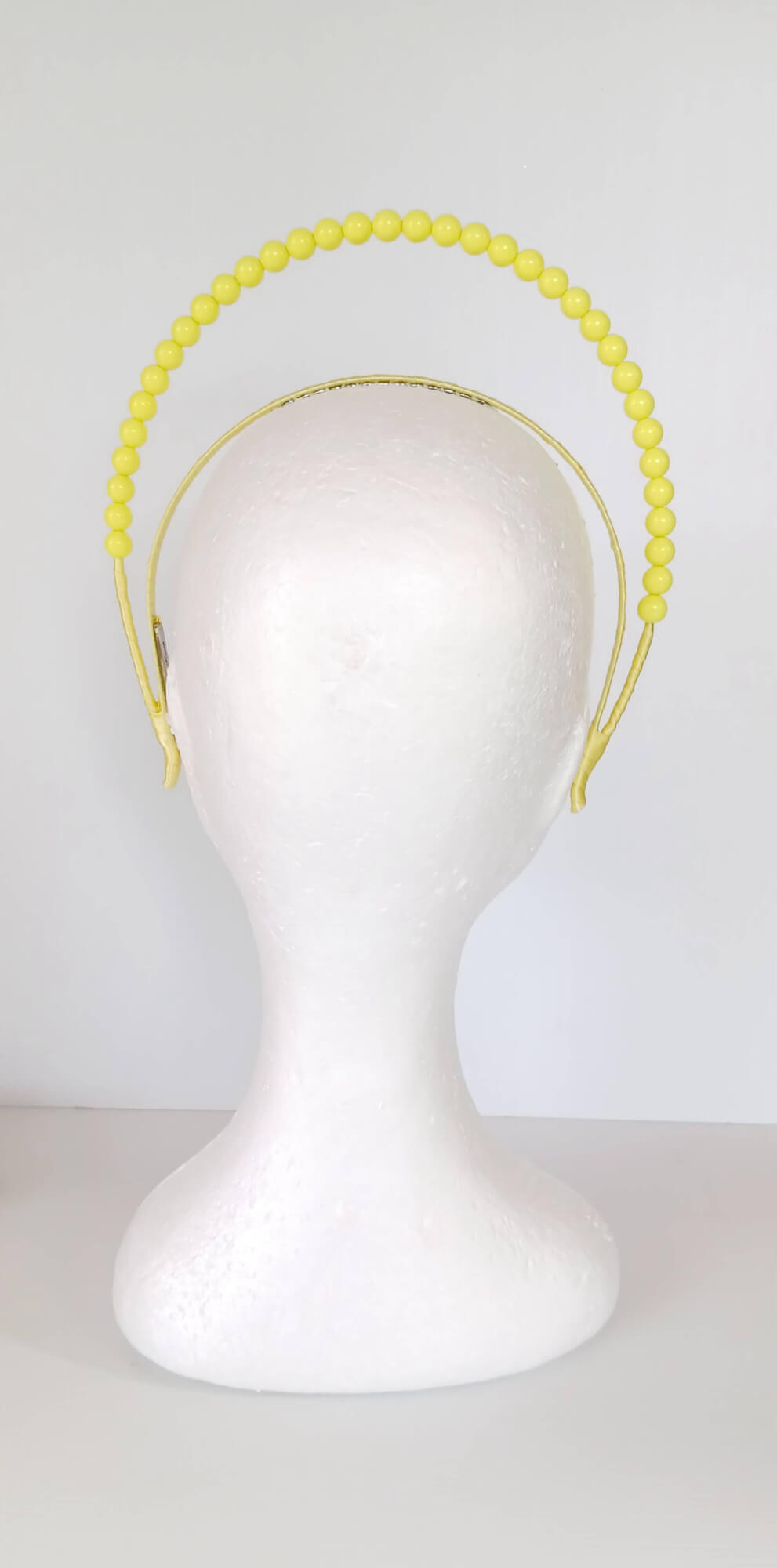 A picture of a Yellow Beaded Headband by Melissa Rath Millinery