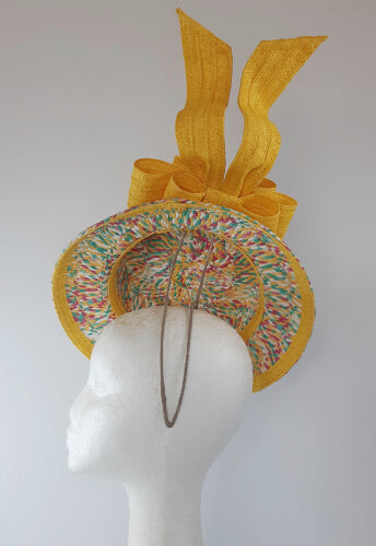 A picture of a Yellow Floating Boater Hat  by Melissa Rath Millinery.
