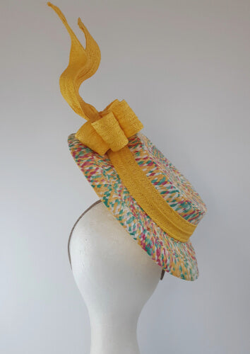 A picture of a Yellow Floating Boater Hat  by Melissa Rath Millinery.