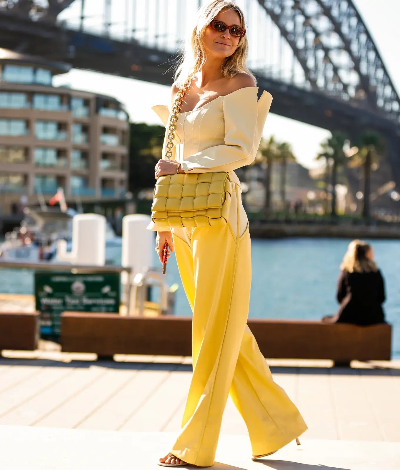 A picture of a woman wearing an outfit in a yellow monochromatic colour scheme.