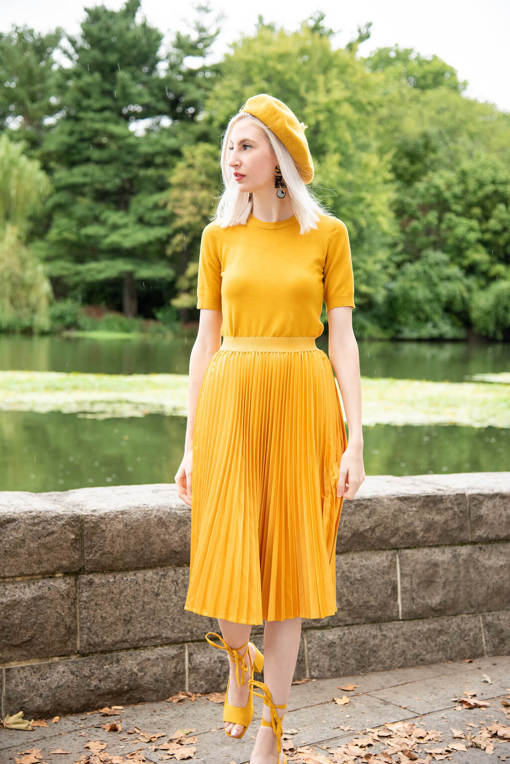 A picture of a woman wearing an outfit in a yellow monochromatic colour scheme.