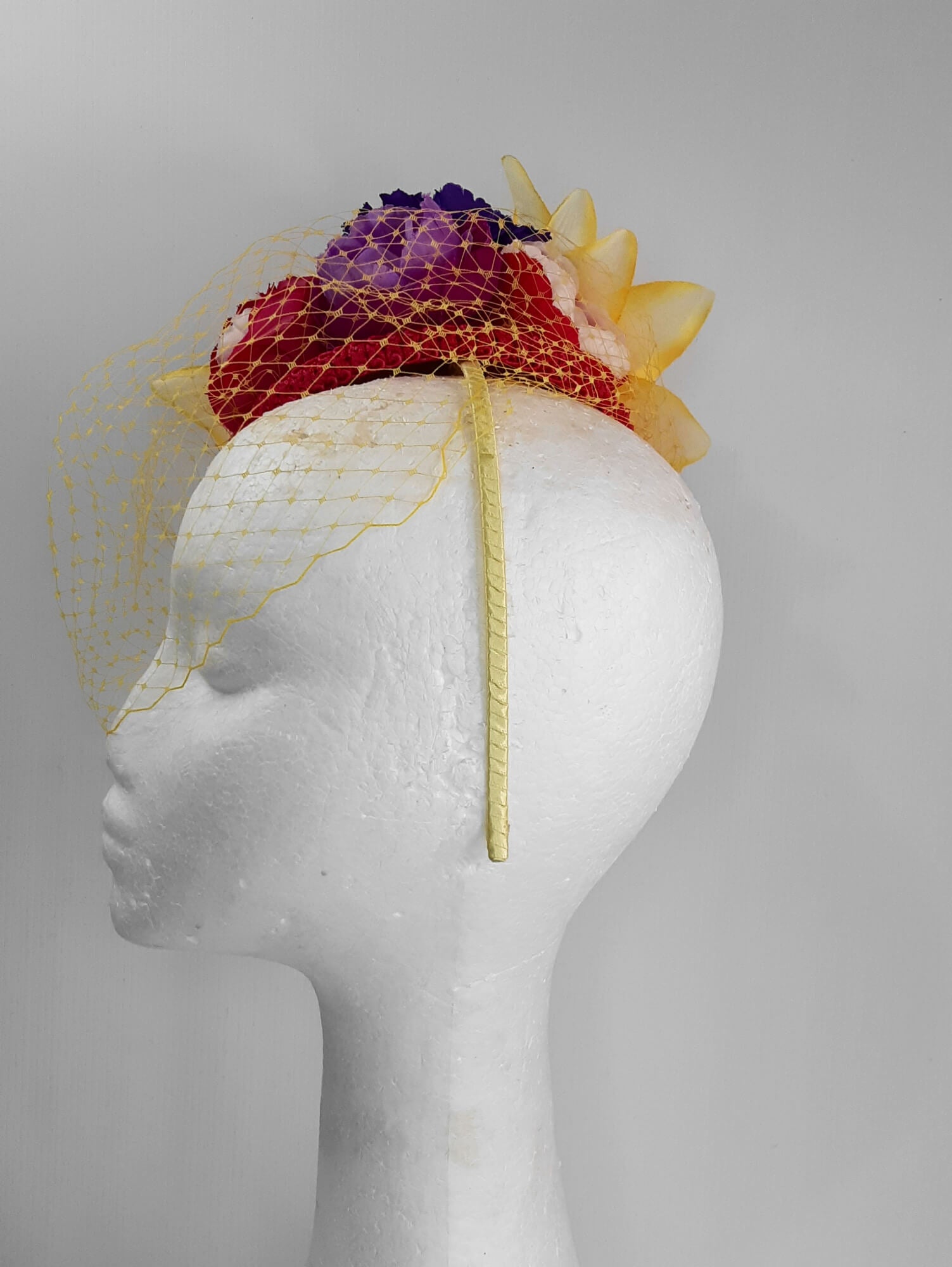 A picture of a Yellow, Pink and Purple Millinery Fascinator by Melissa Rath Millinery.