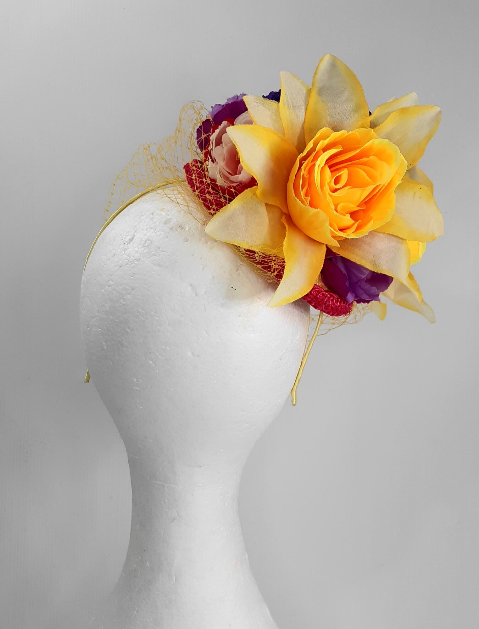 A picture of a Yellow, Pink and Purple Millinery Fascinator by Melissa Rath Millinery.
