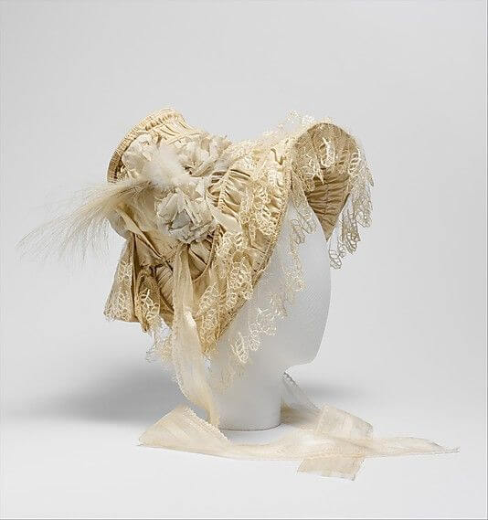 A picture of a french silk and feather bonnet that the Metropolitan Museum of Art has on display from the 1830's